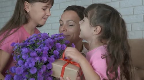 Loving Daughters Surprise Mother with Flowers and Gift