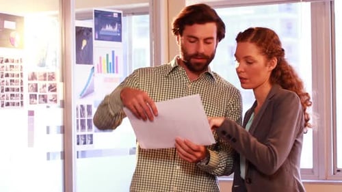Coworkers Reviewing Documents in a Bright Office
