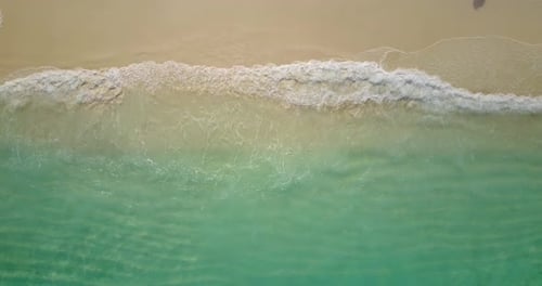 Tropical overhead abstract shot of a sunshine white sandy paradise beach and blue water background
