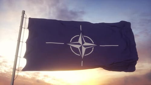 NATO Flag Waving Against a Sunset Sky