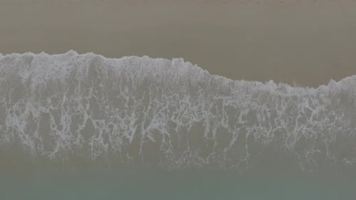 Aerial View of Waves Crashing on the Beach