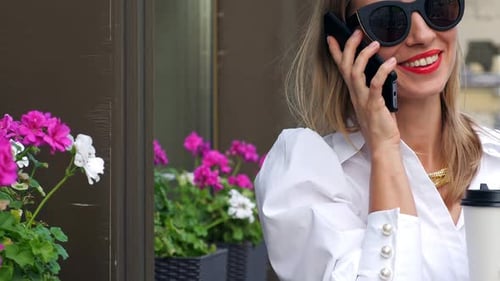 Stylish Woman Chatting on Phone Outdoors