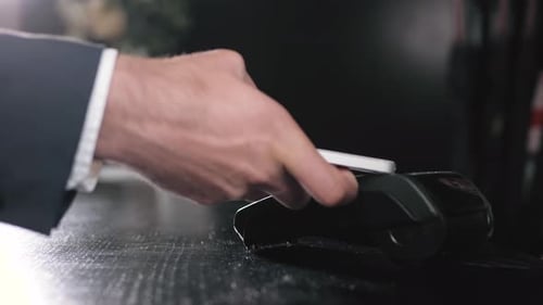 Guest in Hotel Paying Bill with Smartphone Via NFC Technology Businessman in Lobby Pay with Phone