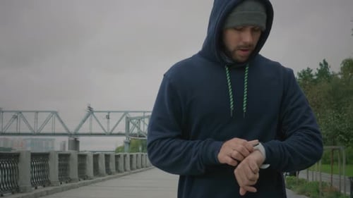 Sportive Man Training In Park Checking Time