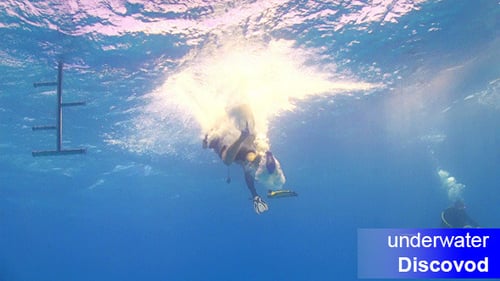 Scuba Diver Jumping into Underwater Blue Ocean