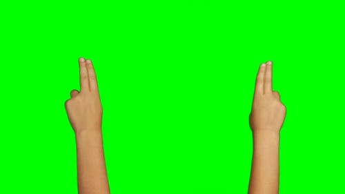 Person making hand gesture against green screen background