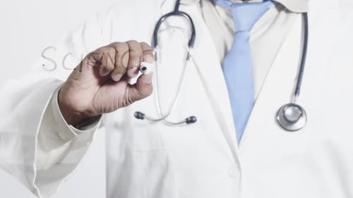 Doctor Writes Science on Clear Screen in Studio