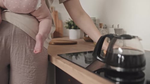 Single Parent of Baby Wiping Kitchen Table