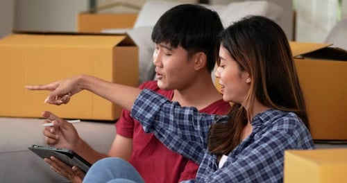 Couple Planning in New Home with Tablet