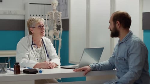 Medical Specialist Having Conversation with Patient at Appointment