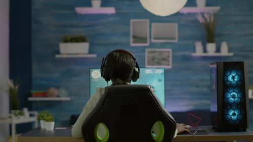 Young Adult Playing Video Game in Gaming Room