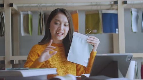 Woman Discusses Fabric Samples on Tablet Video Call