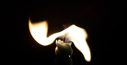 Candle Flame Burning Brightly in the Darkness