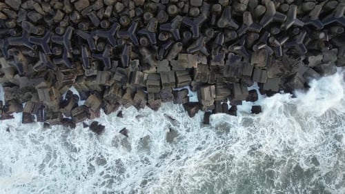 Waves Crashing Against Rocky Tetrapod Embankment From Above