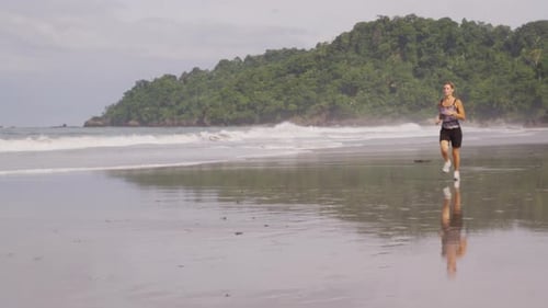Woman running on beach, Costa Rica. Shot on RED EPIC for high quality 4K, UHD, Ultra HD resolution.