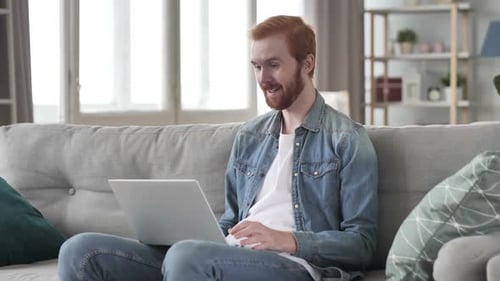 Red-haired Man Video Calling on Laptop