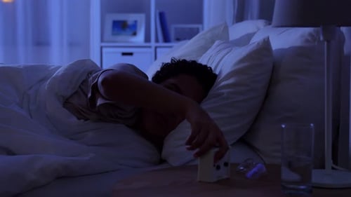 Person Sleeping Soundly in a Bed at Night