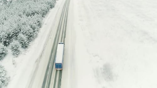 Truck moving along snow covered winter nature
