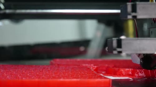 3D Printer Creating a Red Object