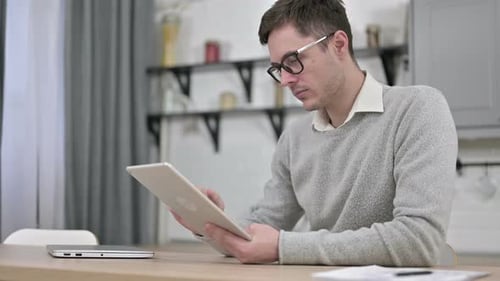 Happy Young Man Using Tablet PC