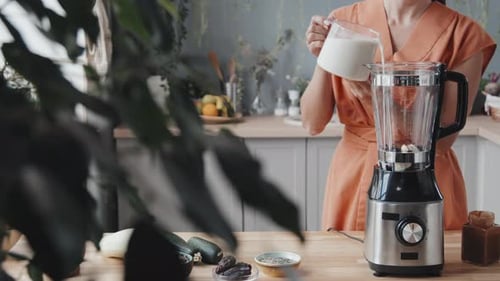 Woman Prepares Healthy Smoothie in Kitchen