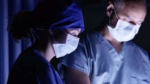 Medical Team Working in Operating Room at Night
