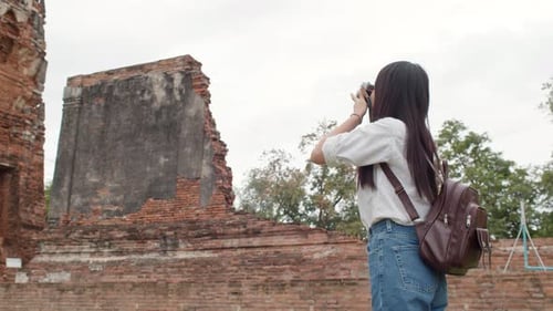 Japanese backpacker female enjoy her journey at amazing landmark in traditional city.