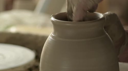 Pottery Artist Shaping Clay on Wheel