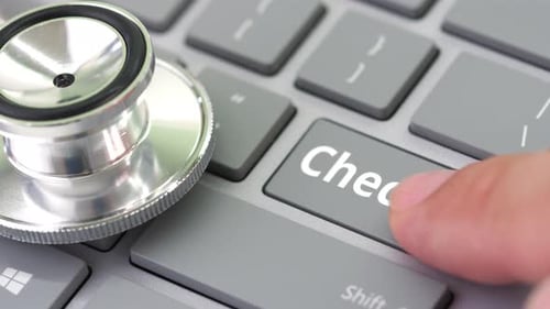 CHECKUP Key Being Pressed on a Keyboard Near Stethoscope