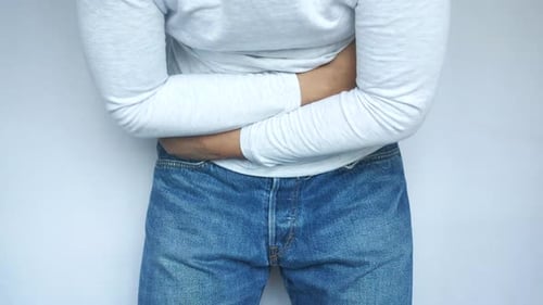 Young Man Suffering Stomach Pain Close Up