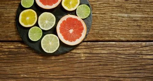 Sliced Citrus Fruits Displayed on Slate Board