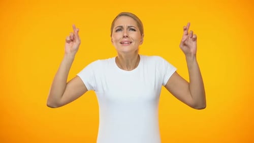 Caucasian Lady Crossing Fingers Hoping for Luck, Making Wish, Expectations
