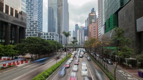 Hong Kong Street with Busy Traffic and Skyscraper Office at Day
