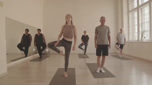 Group of People Standing on One Leg Meditating