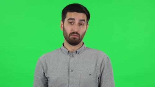 Portrait of Brunette Guy Is Listening Attentively and Nodding His Head Pointing Finger at Viewer