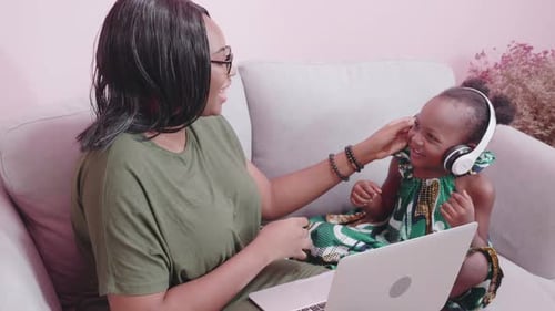 Woman and Child Using Laptop Together at Home