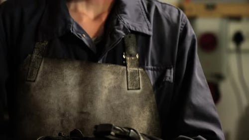 Female welder holding wrench tool