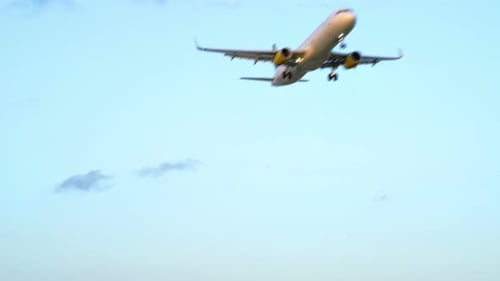 Airplane Approaching the Camera in a Cloudy Sky