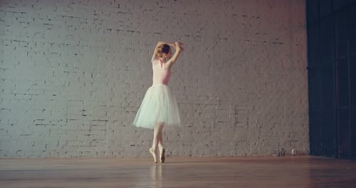 Young Ballerina Dancing Gracefully in a Studio