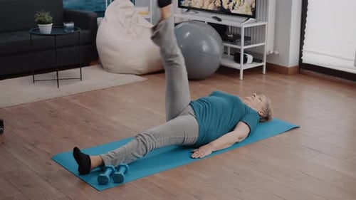Senior Woman Exercising at Home on Yoga Mat