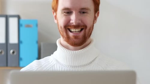 Close-up of Redhead Man Celebrating Success with Excitement