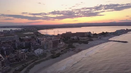 Aerial view of Pomorie city that is located on Black Sea shore at sunset. Top view of sand