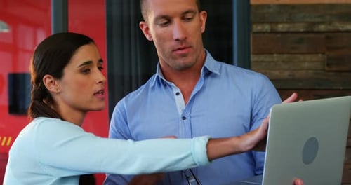 Adults Collaborating on a Laptop at Work