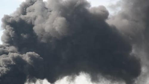 Towering Plumes of Gray and Black Smoke