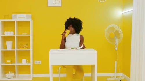 Black Woman Is Eating Pizza and Drink Beverage