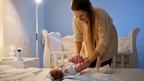 Loving Mother Caring for Infant in Nursery at Night