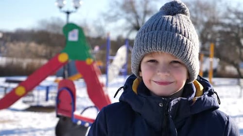 Smiling Child Wearing Winter Hat Outdoors