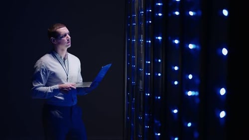 IT Technician in Data Center Digital Server Room Controlling Work of Rack Server Cabinets with a