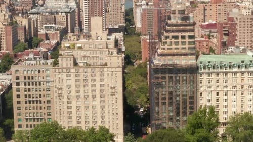 AERIAL: Flight Along Beautiful New York City Street at Central Park on Sunny Summer Day