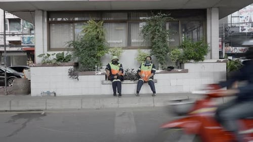Street Cleaning Workers Sitting Outside A House Along The Street In Bangkok Thailand